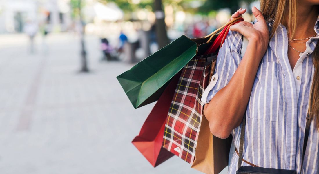 Woman holding shopping bags in city